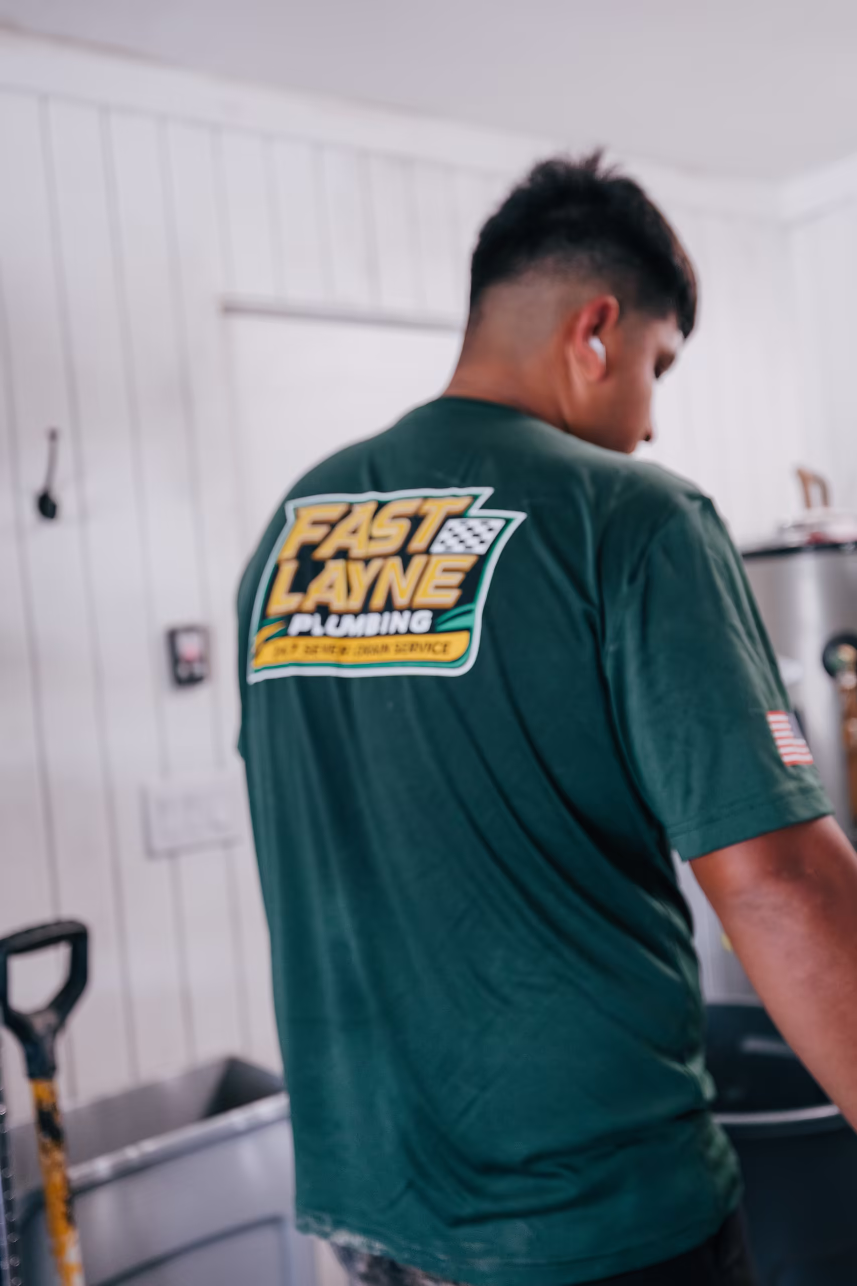 Fast Layne plumber in company uniform on a job